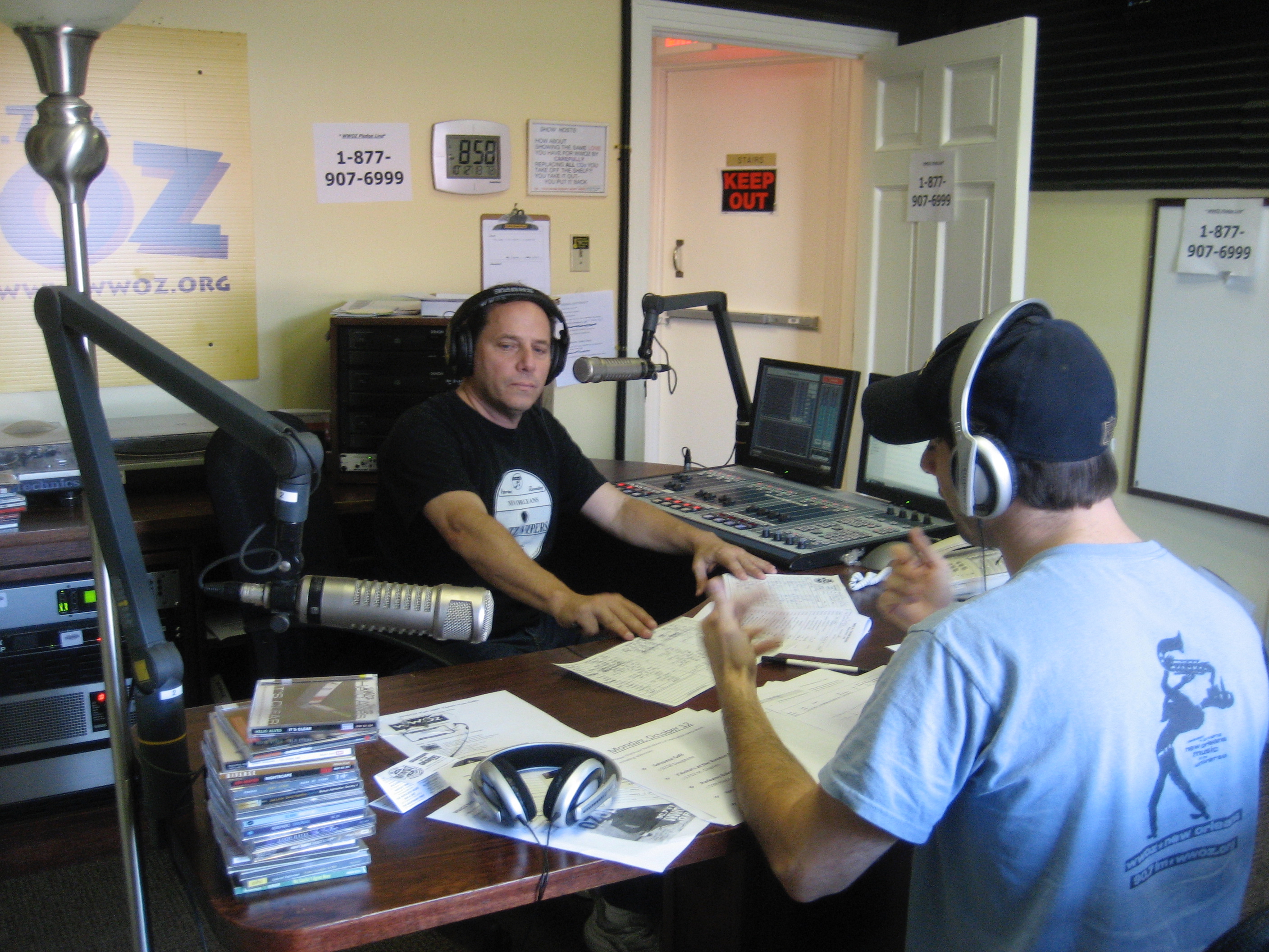 Voice-over recording setup with studio microphone, pop filter, headphones, and a laptop showing an audio waveform