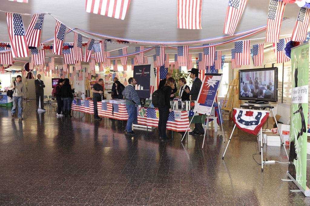 Venue registration area with a roll-up banner, poster board, and staffed information tables